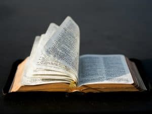 Open Bible with highlighted verses, symbolizing the inspired Word of God and divine revelation