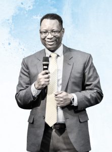 a man in a suit holding a microphone. Image depicting the journey of resilience through faith and education, highlighting personal growth and triumph over adversity.